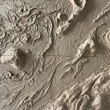 Textured wall panel with embossed patterns resembling natural landscapes