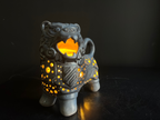 Decorative lion figurine with glowing interior on a dark background
