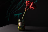 Vase with a red flower against a dark background