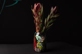 Decorative vase with a floral arrangement on a black background