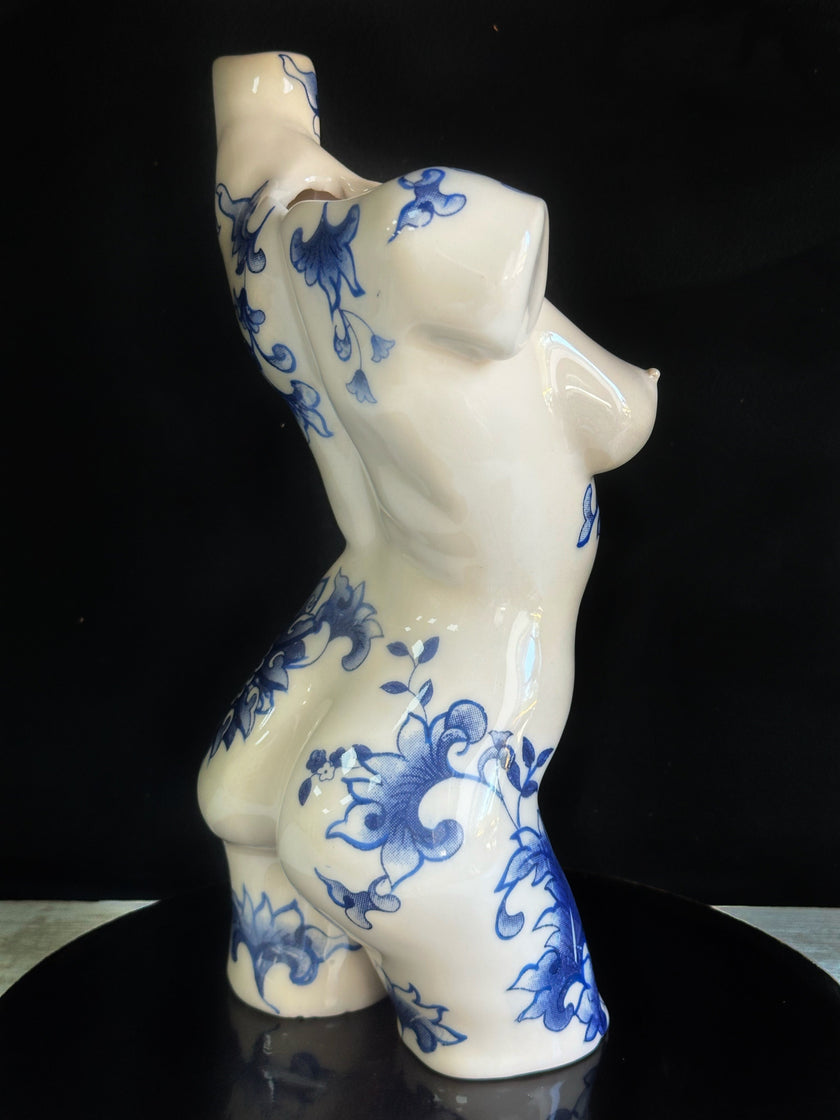 Ceramic vase with blue floral patterns on a black background