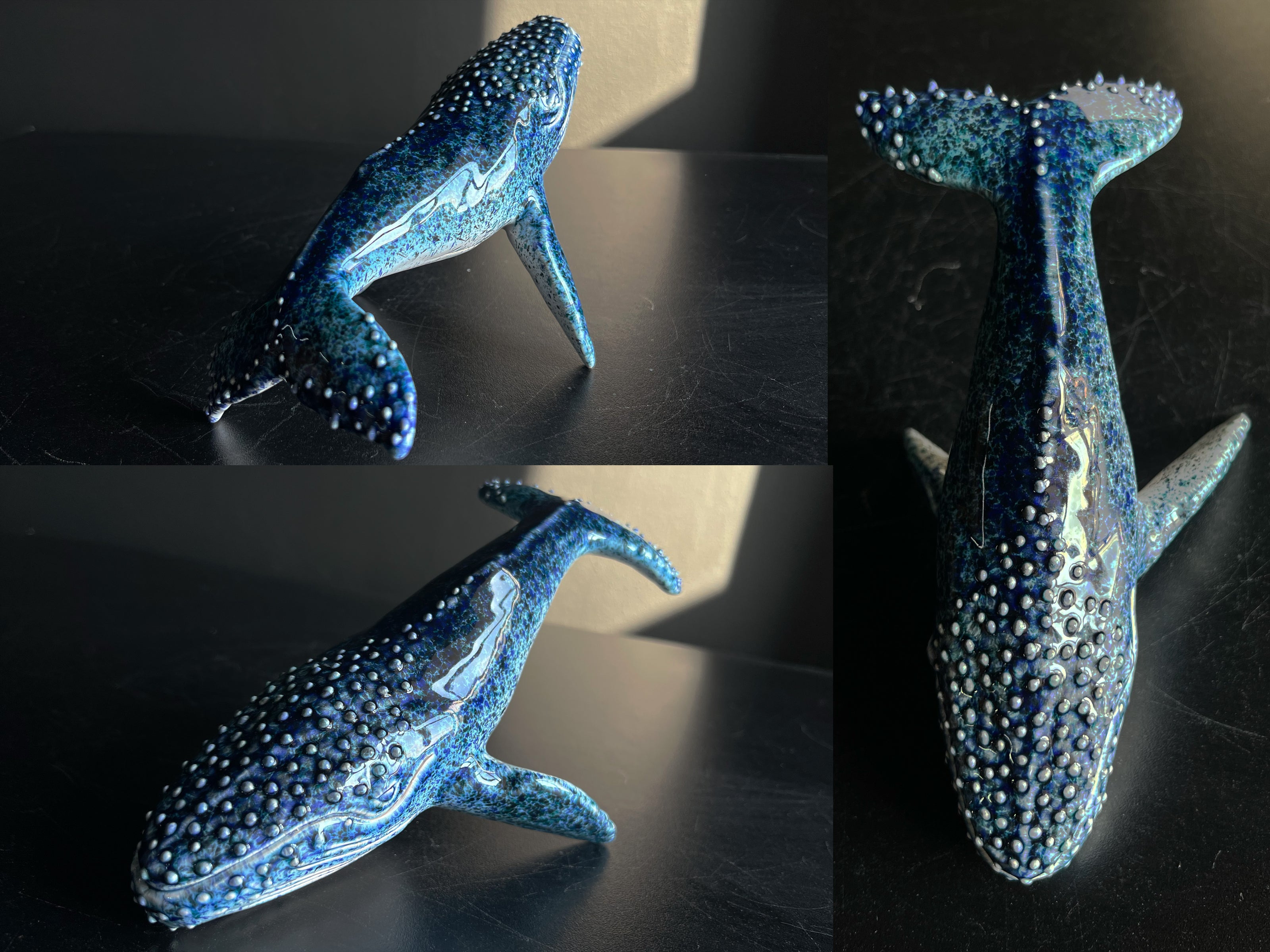 Blue ceramic whale figurine on a dark surface