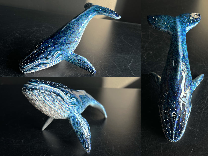 Blue whale figurine on a dark surface