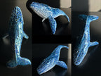 Collage of a blue whale figurine on a black background