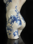 Ceramic vase with blue floral patterns on a black background