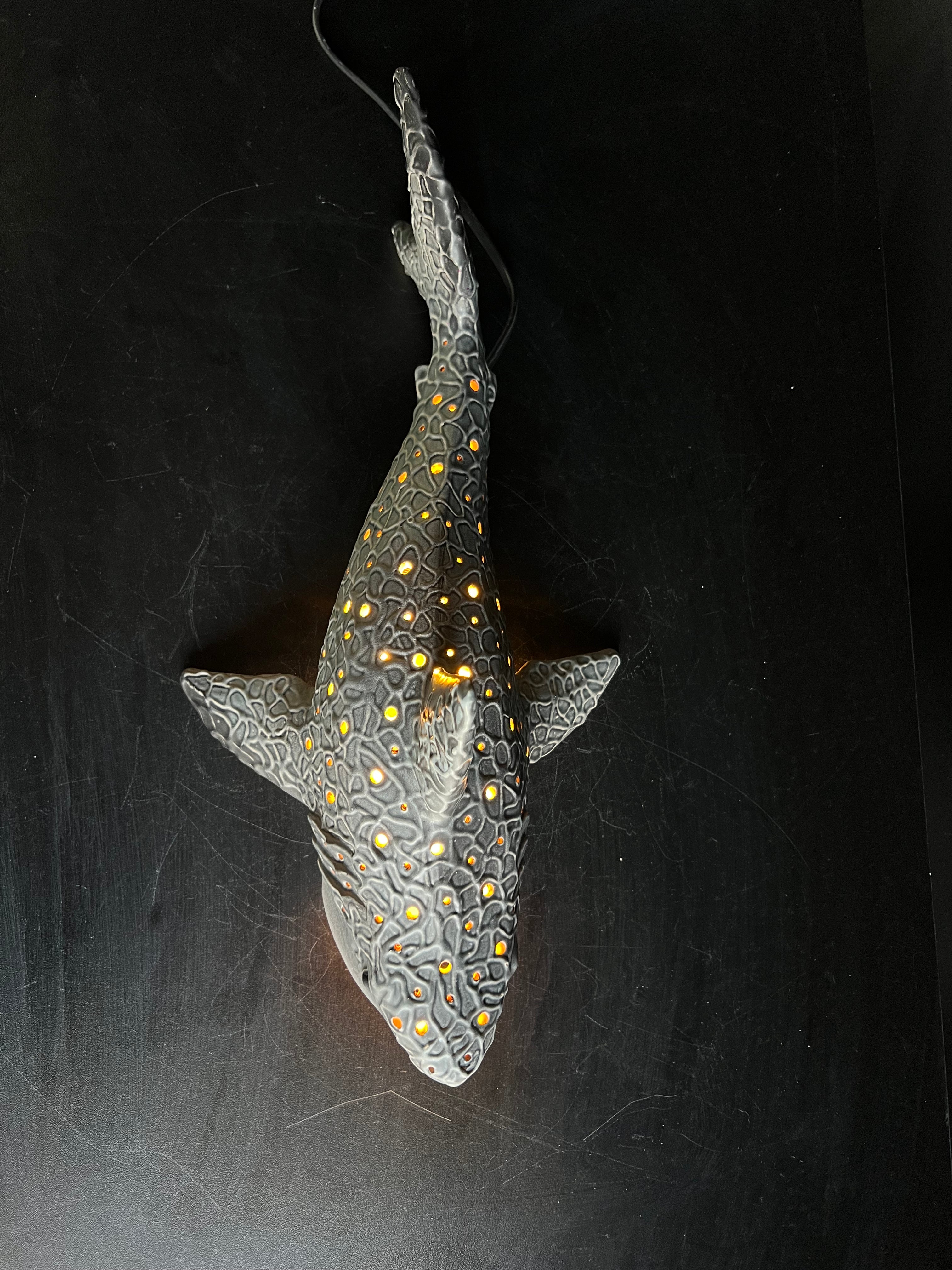 Decorative shark ornament with a dark background