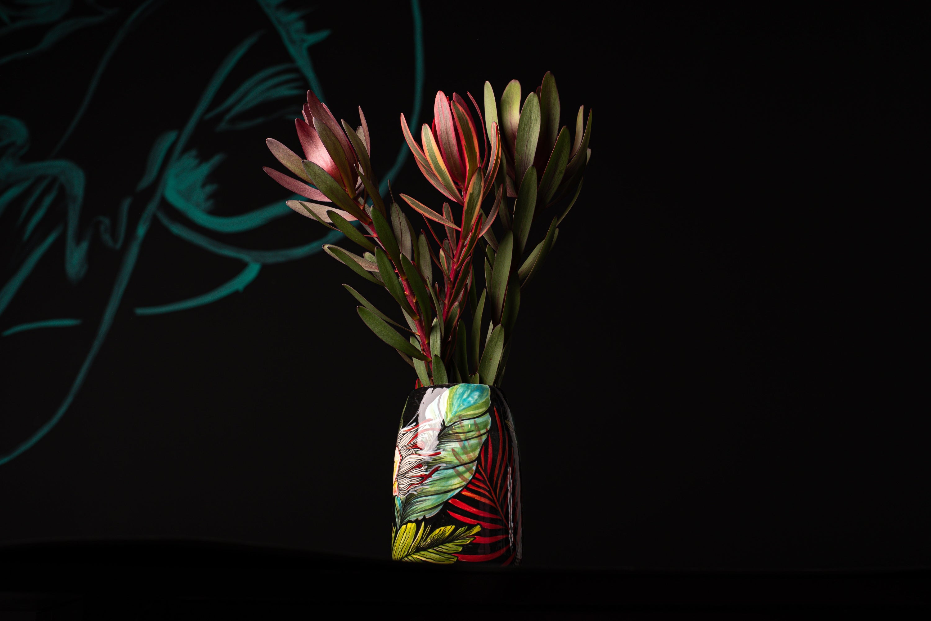 Vase with plants on a black background