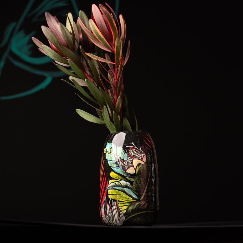 Colorful handpainted ceramic vase on a dark background